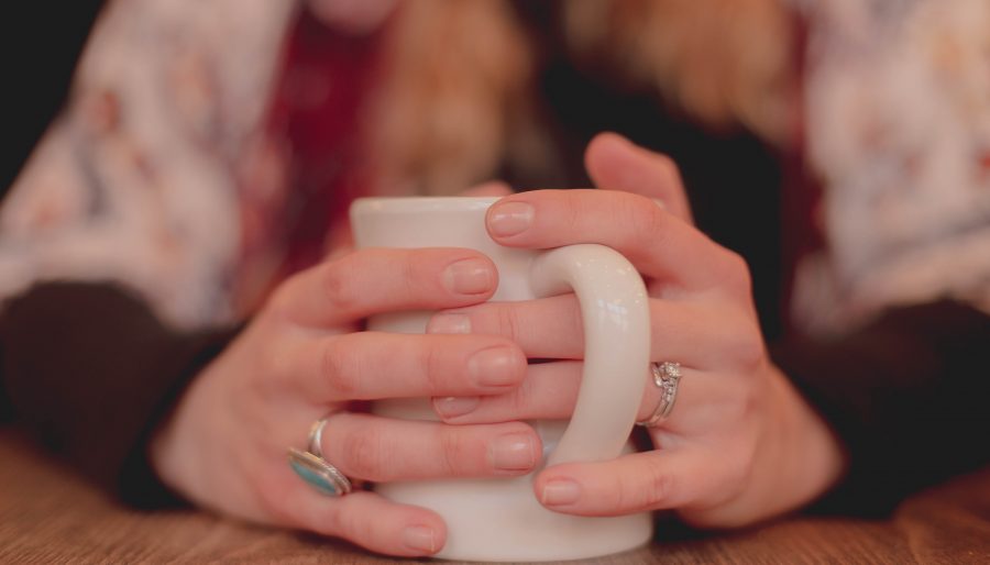 Hands holding a cup