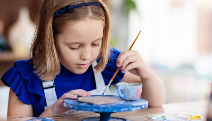Image of a girl pottery painting.