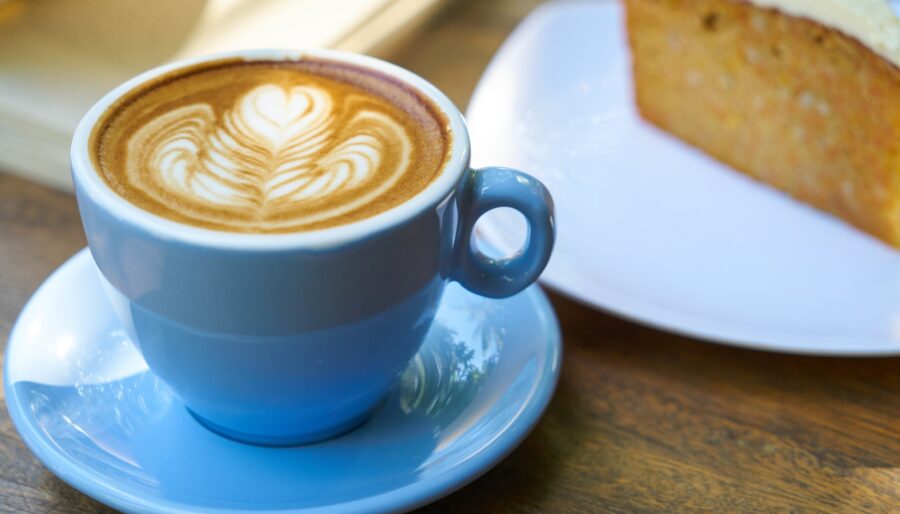 Image of a blue mug with coffee and a slice of cake